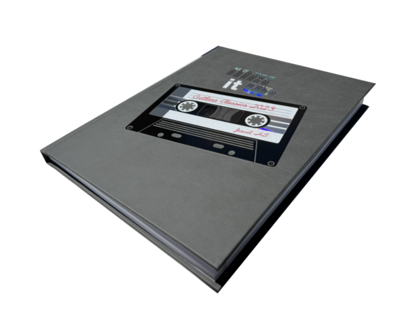 Yearbook angled to see pages, cover features a cassette tape image